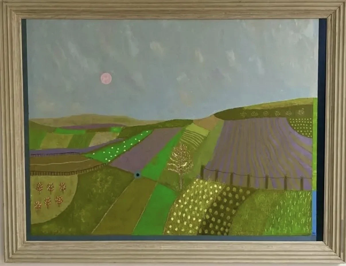 A painting depicting a colorful landscape with rolling hills, patches of green, purple, and yellow fields, some with floral or geometric patterns, under a cloudy sky with a pink moon.