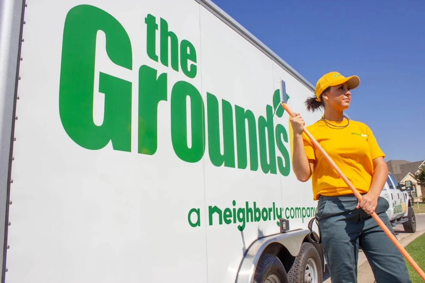 Professional Grounds Guys crew providing seasonal property services including spring cleanup, mulch installation, and shrub trimming in New Lenox, Illinois.