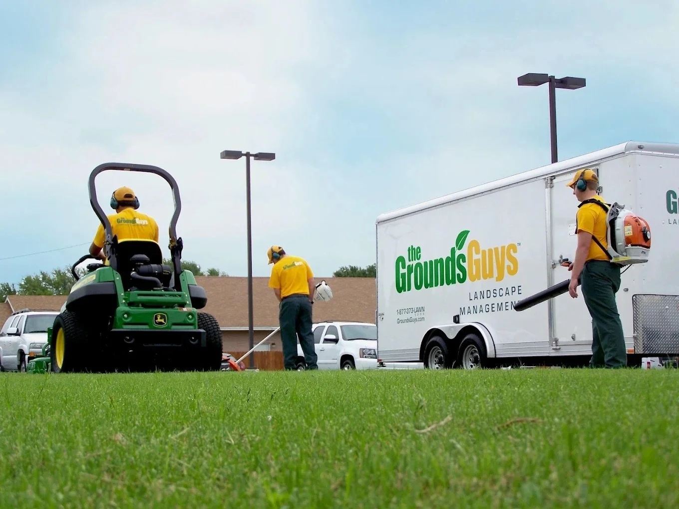 Professional lawn care crew providing mowing, lawn maintenance, and turf care services for a residential property in New Lenox, Illinois.