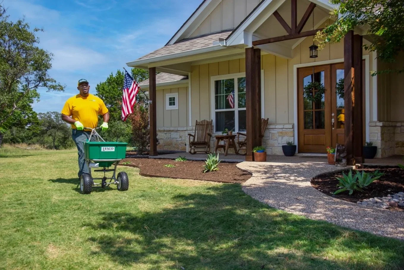 Technician applying professional fertilizer and weed control treatment to improve lawn health at a residential property in New Lenox, Illinois.