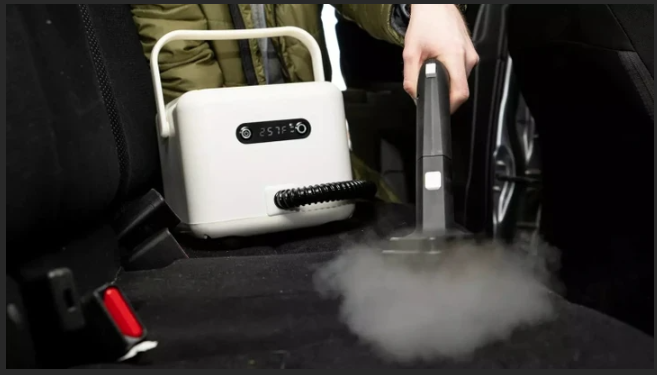 Person using a portable device to create fog or vapor in the back seat of a car.