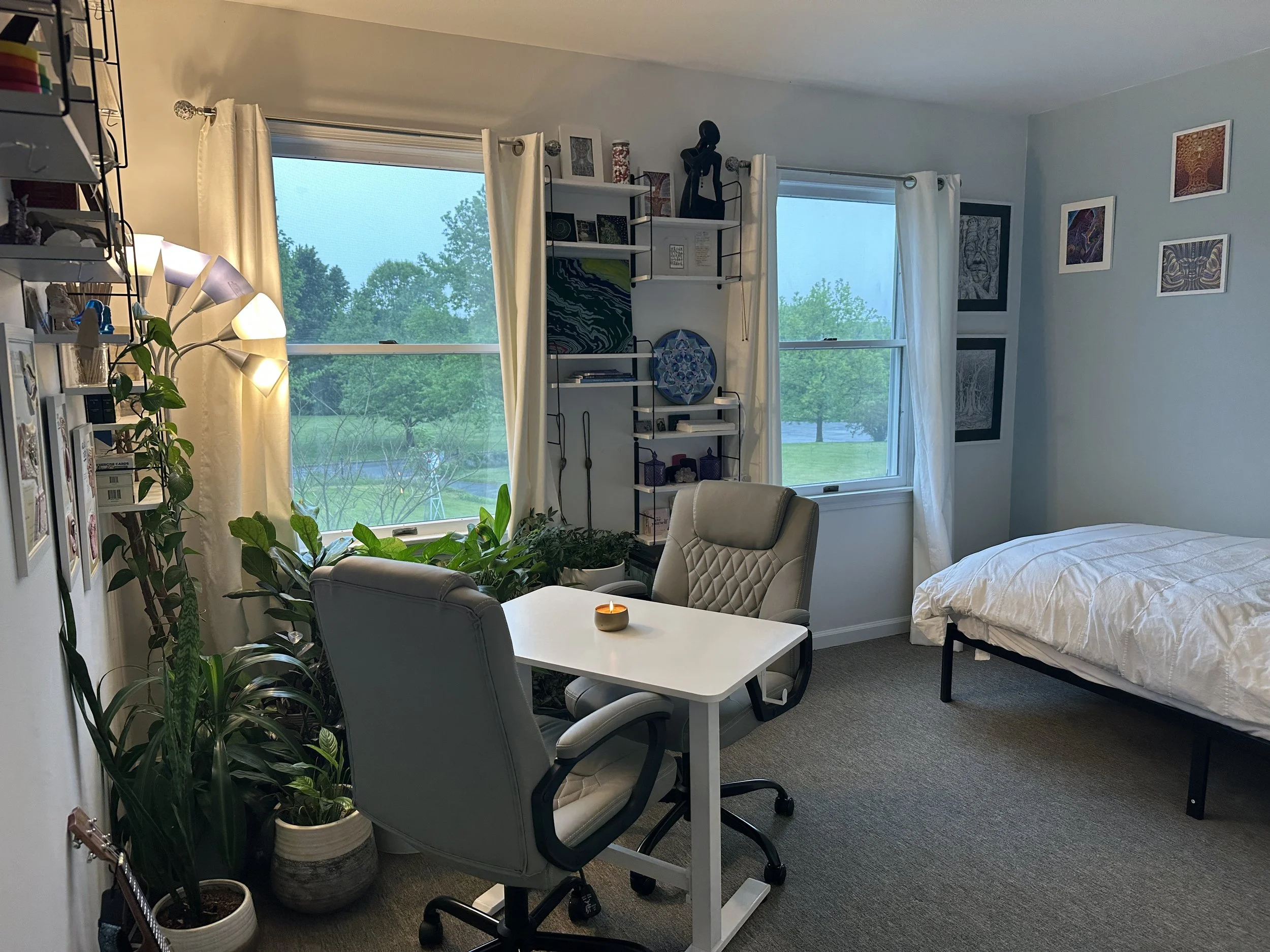 Blending comfort with curiosity, the space features living plants, soft lighting, sacred geometry, and meaningful artwork designed to support emotional safety and personal exploration. The therapeutic interview is unhurried and conversational, offeri