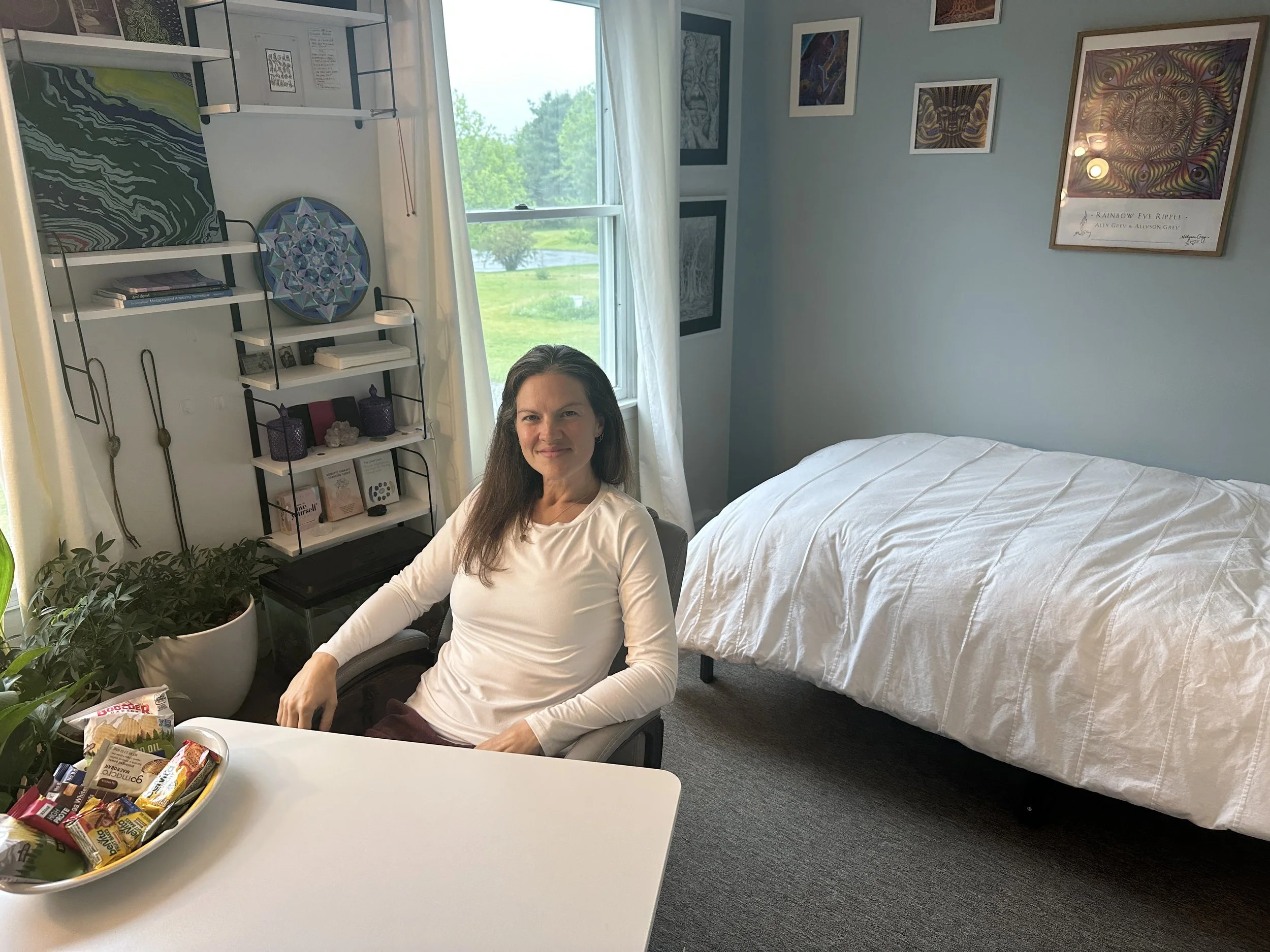 Julie, founder of Oversoul Sanctuary, within the therapeutic interview space where each QHHT® session begins through open conversation, reflection, and deep listening. Light refreshments are made available to help clients feel cared for, comfortable,
