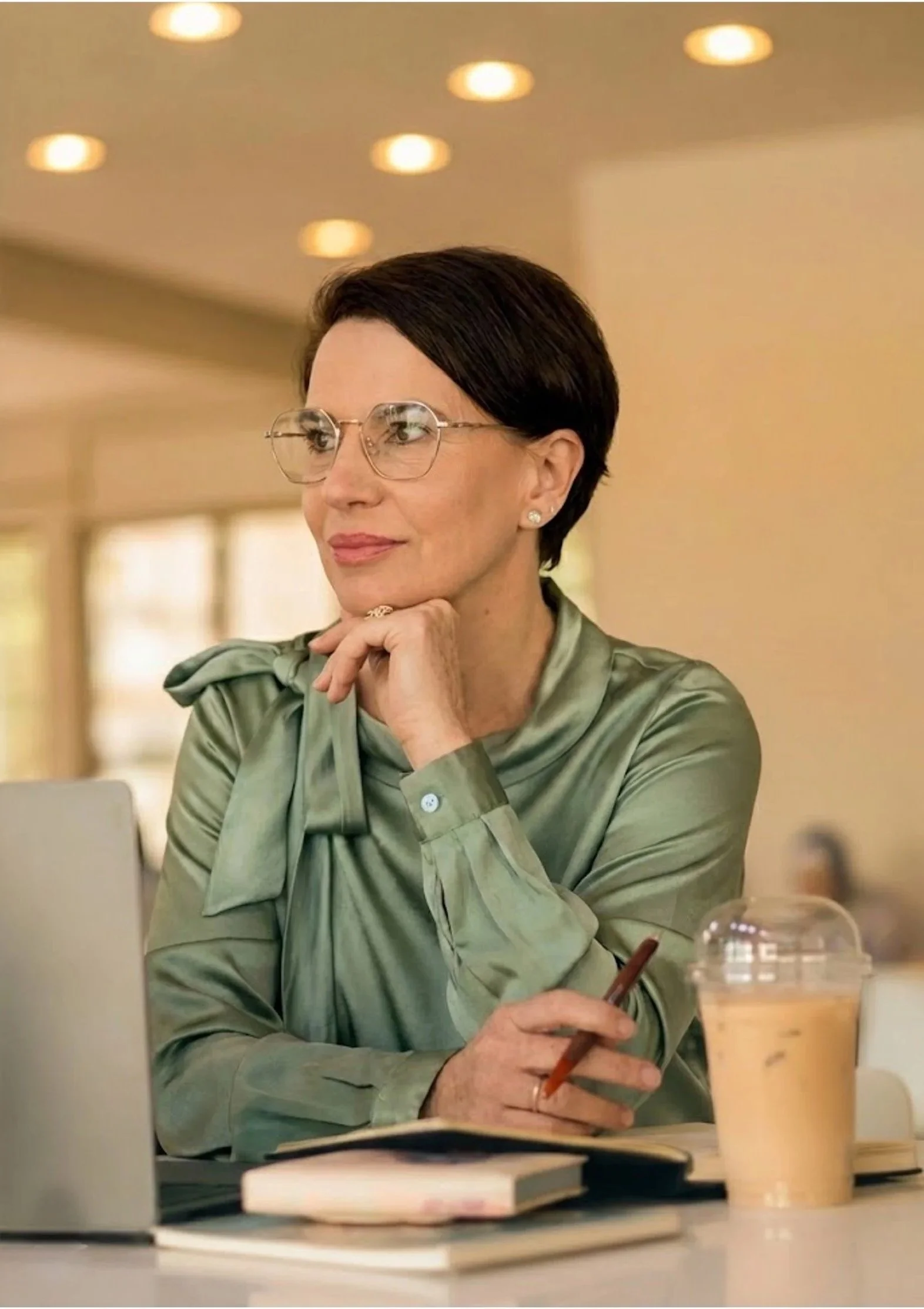 Woman, listening closely while sitting in front of a computer