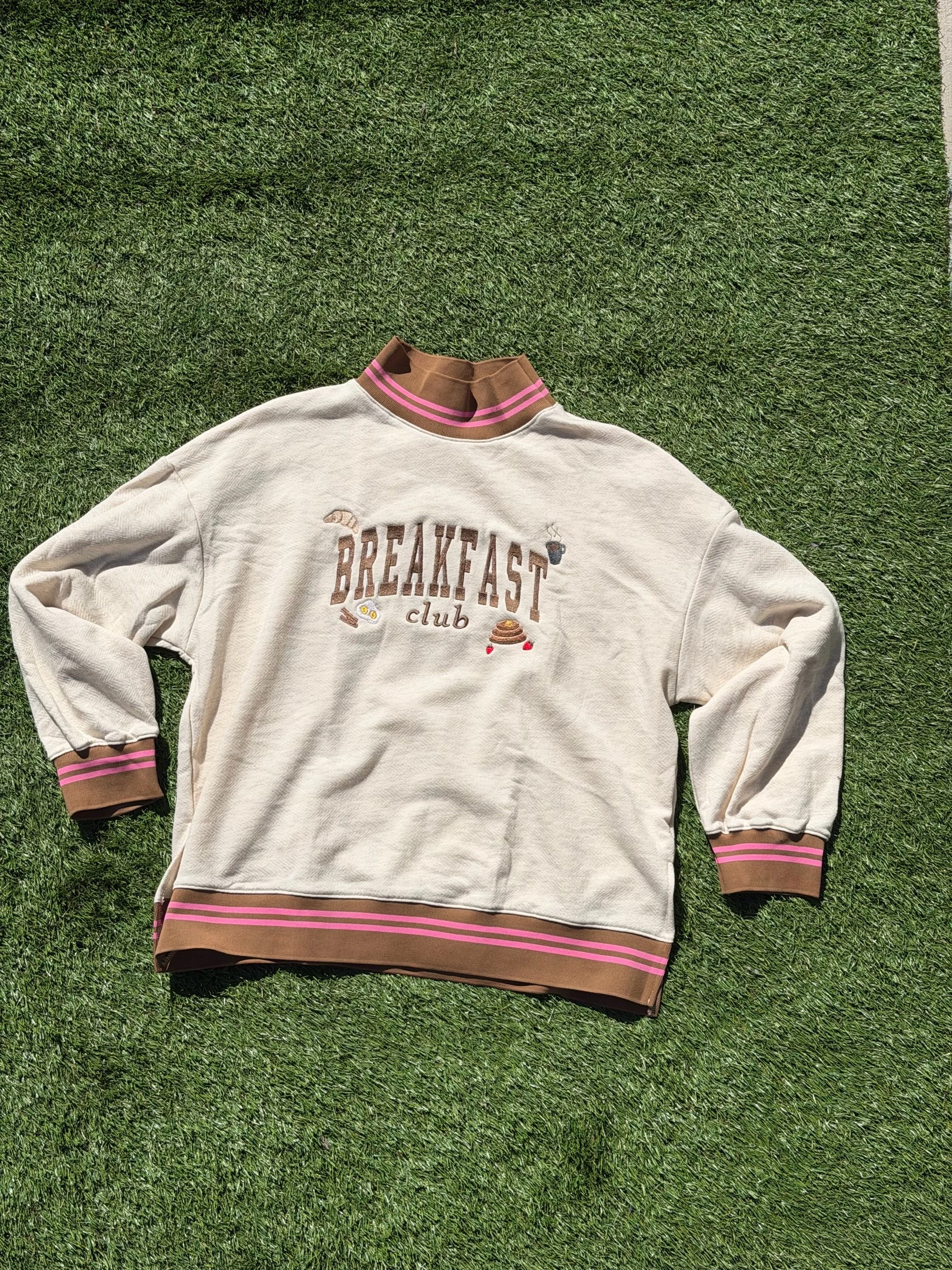 Cream mockneck with Breakfast club across the chest with little breakfast doodles.