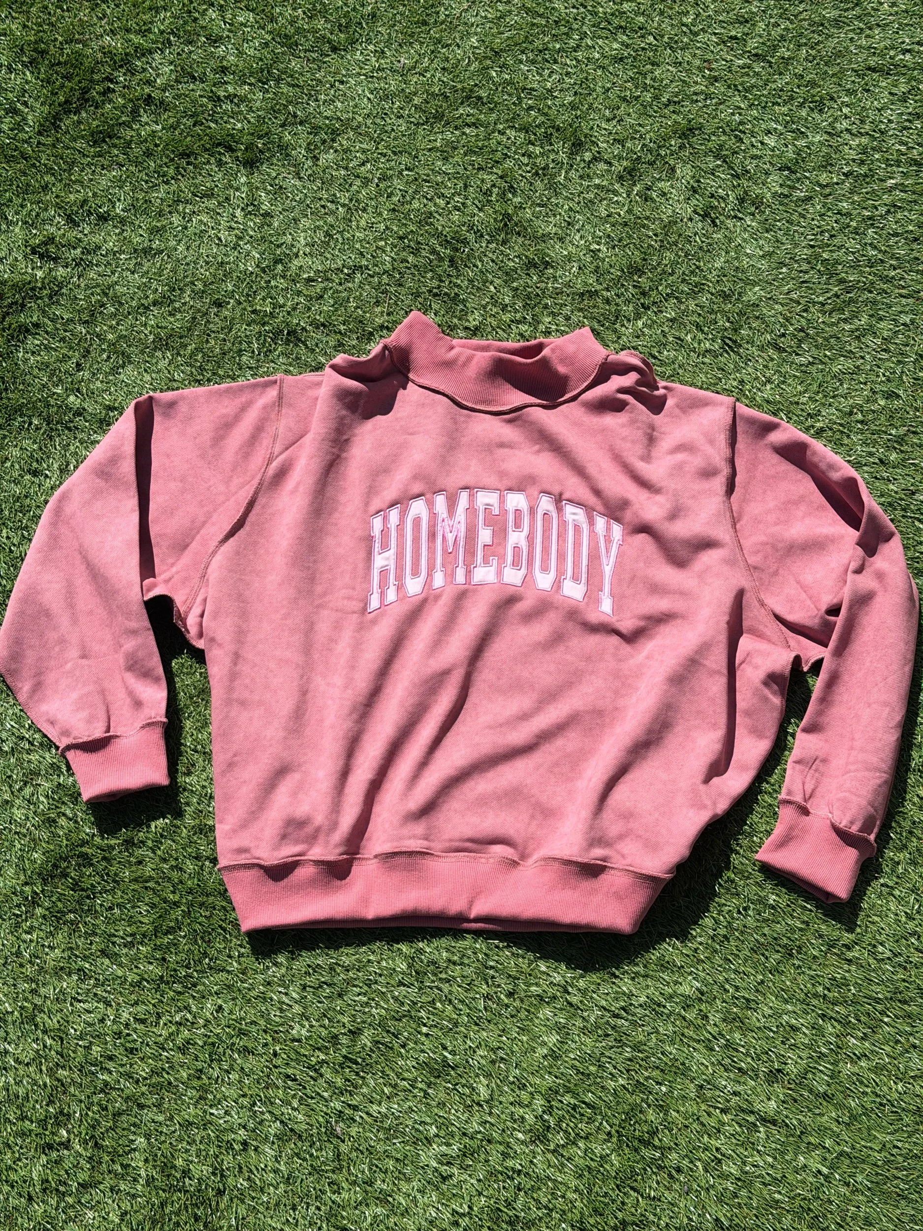 Pink mockneck with Homebody across the chest