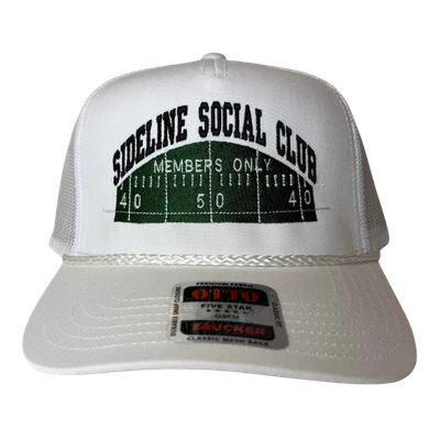 White trucker hat with green football field embroidery and the text 'Sideline Social Club Members Only' embroidered on the front.