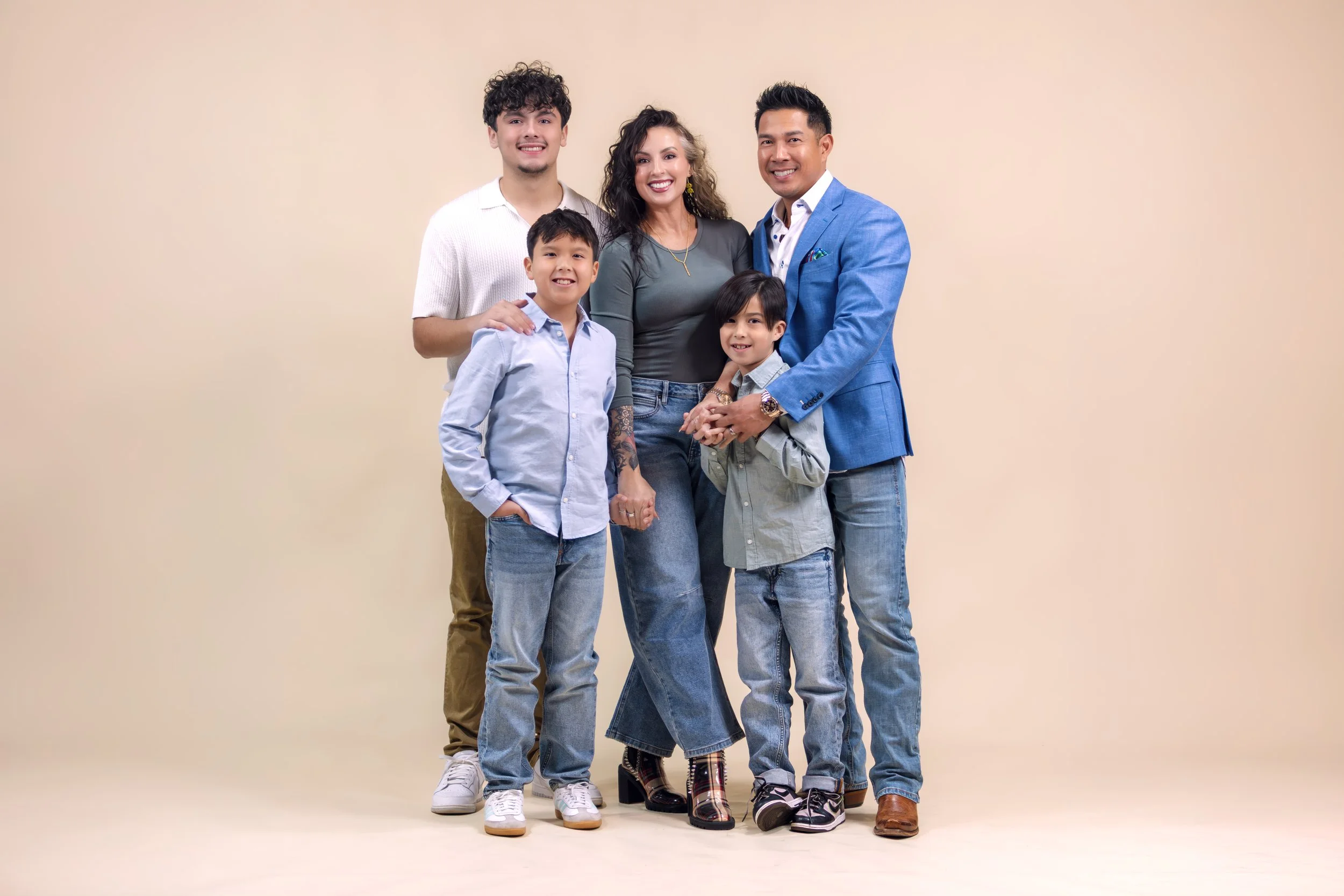 Family portrait studio session in Tyler Texas neutral backdrop smiling family