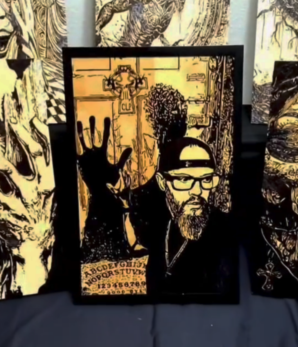Completed custom wood-burned portrait created for a paranormal warrior nonprofit, depicting a man with raised hand, occult symbolism, and a spirit board, rendered through dark handcrafted pyrography and symbolic wood-burning detail