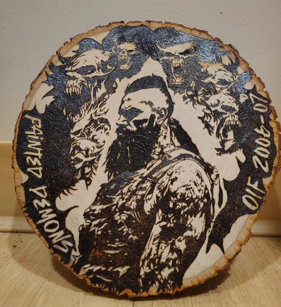 Handcrafted portrait wood burning on live-edge wood featuring detailed line work and expressive imagery, showcasing the artist’s signature pyrography style
