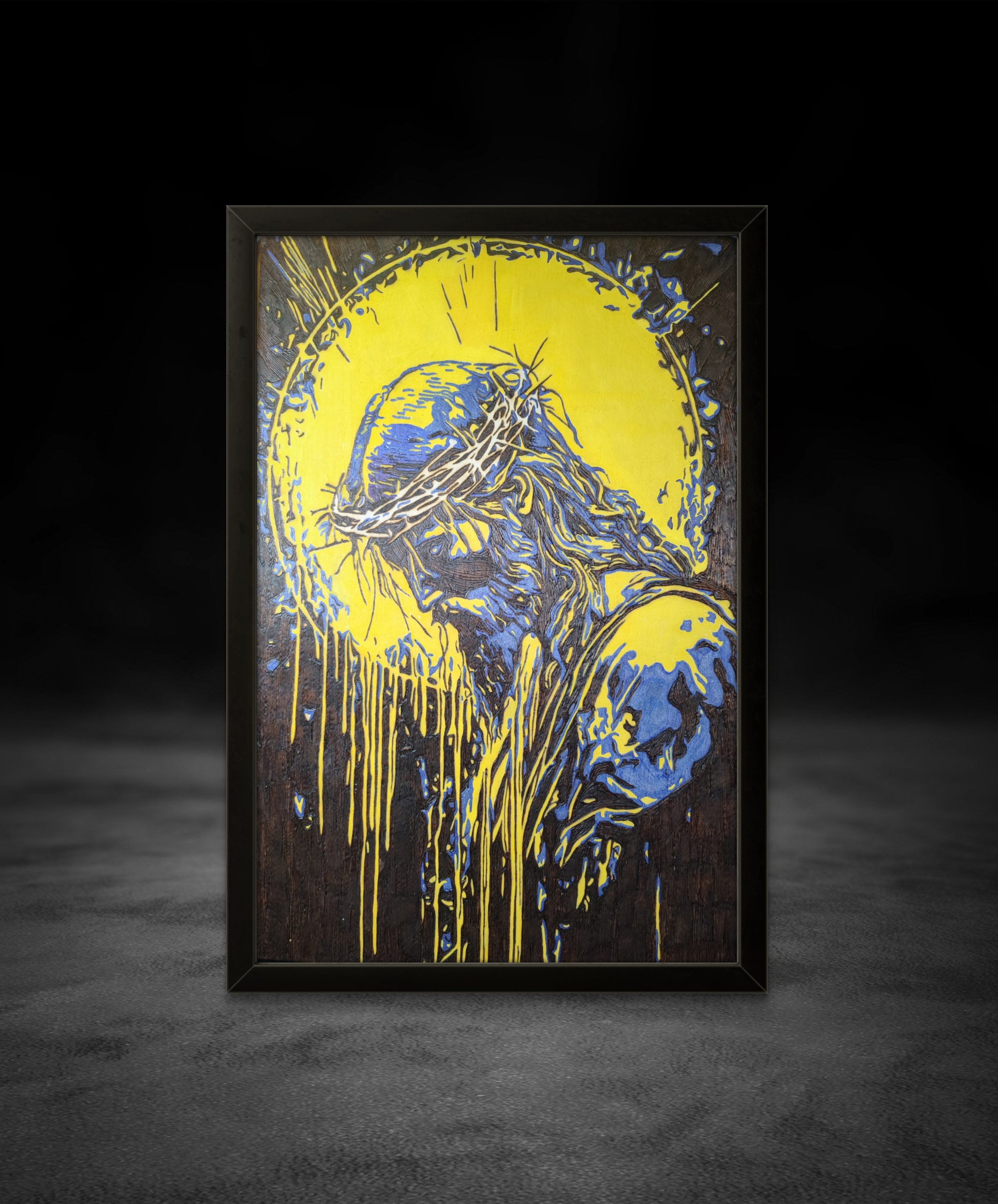 Close-up view of detailed wood-burned and painted wall art featuring radiant halo effects and expressive line work on basswood