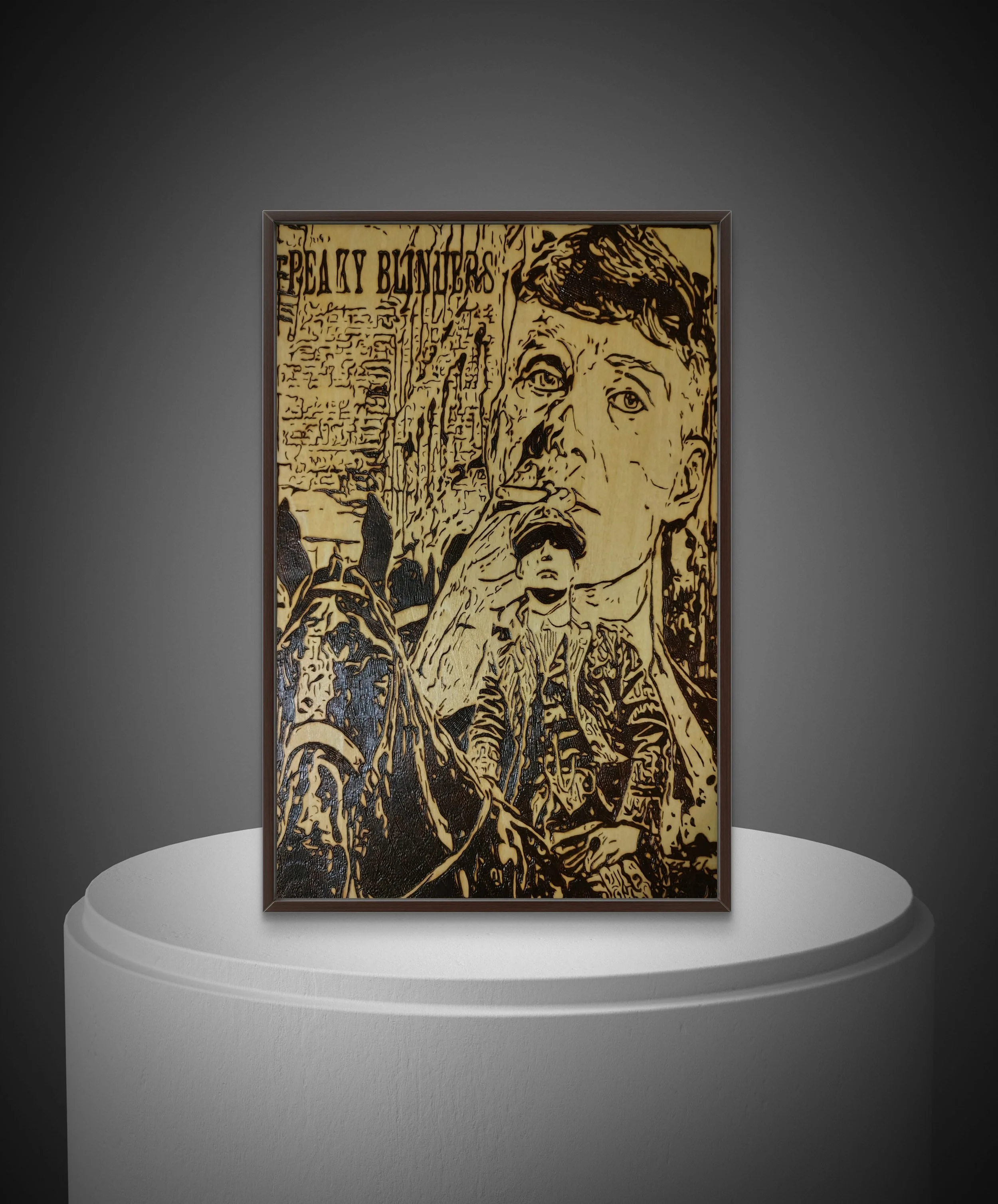 Hand-burned Peaky Blinders inspired wood artwork showing a dual-expression figure burned into basswood, framed and displayed against a neutral background.