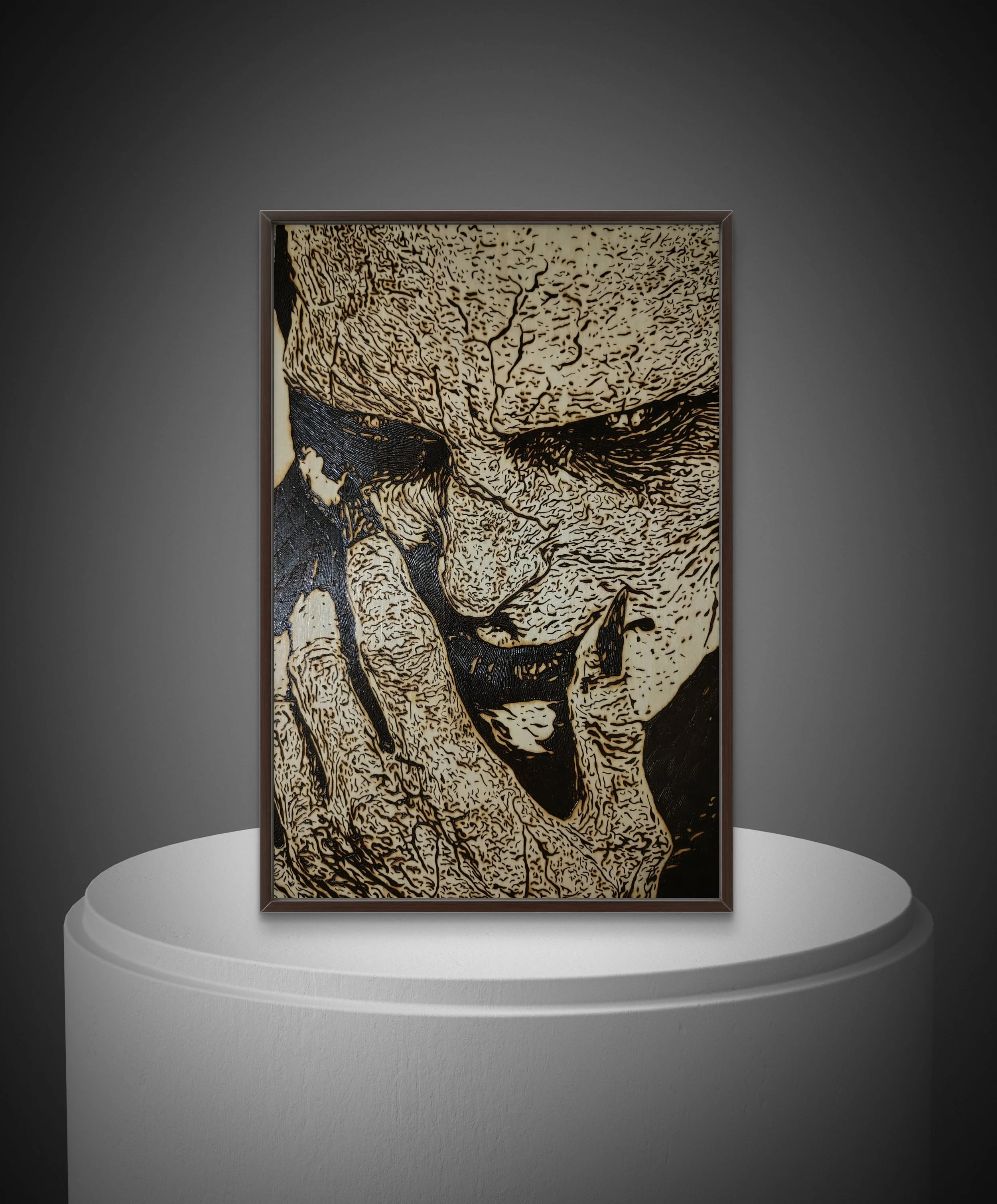 Hand-burned wood artwork titled “Entity’s Companion” featuring an intense close-up figure burned into natural basswood, framed and displayed on a pedestal
