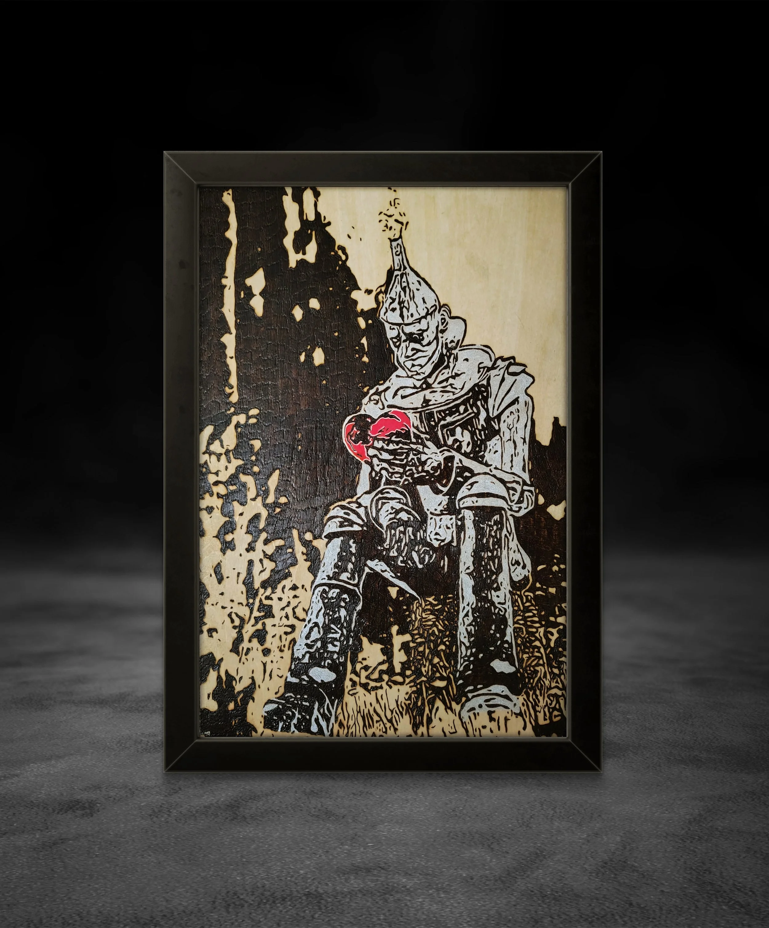 Hand-burned wood art depicting an armored figure holding a red heart, burned into basswood with dramatic contrast