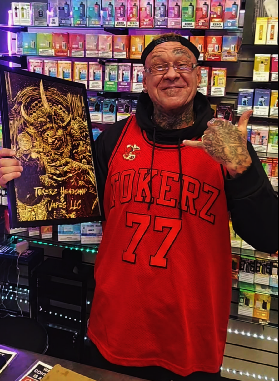 Custom wood-burned business portrait displayed in a retail setting, featuring a horned fantasy figure rendered in bold handcrafted pyrography for a head shop brand Tokerz Headshop