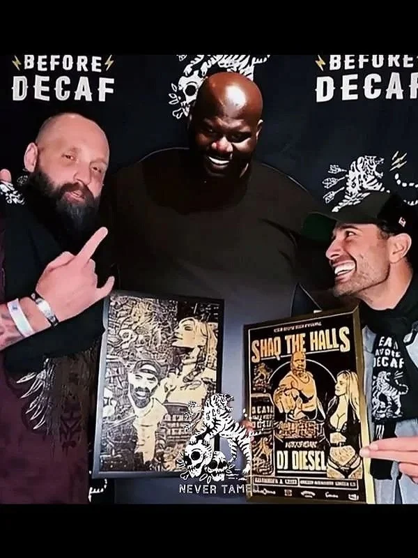 Picture of artist with his wood burning piece he made for shaq