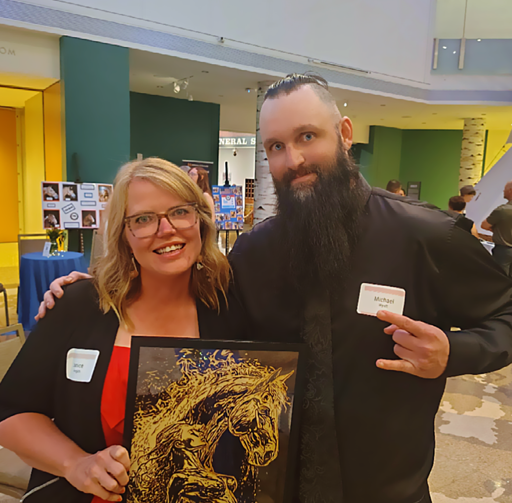 In-person presentation of a custom wood-burned horse artwork at a nonprofit fundraiser auction for The Right Step LLC, highlighting detailed handcrafted pyrography and equine realism created on wood