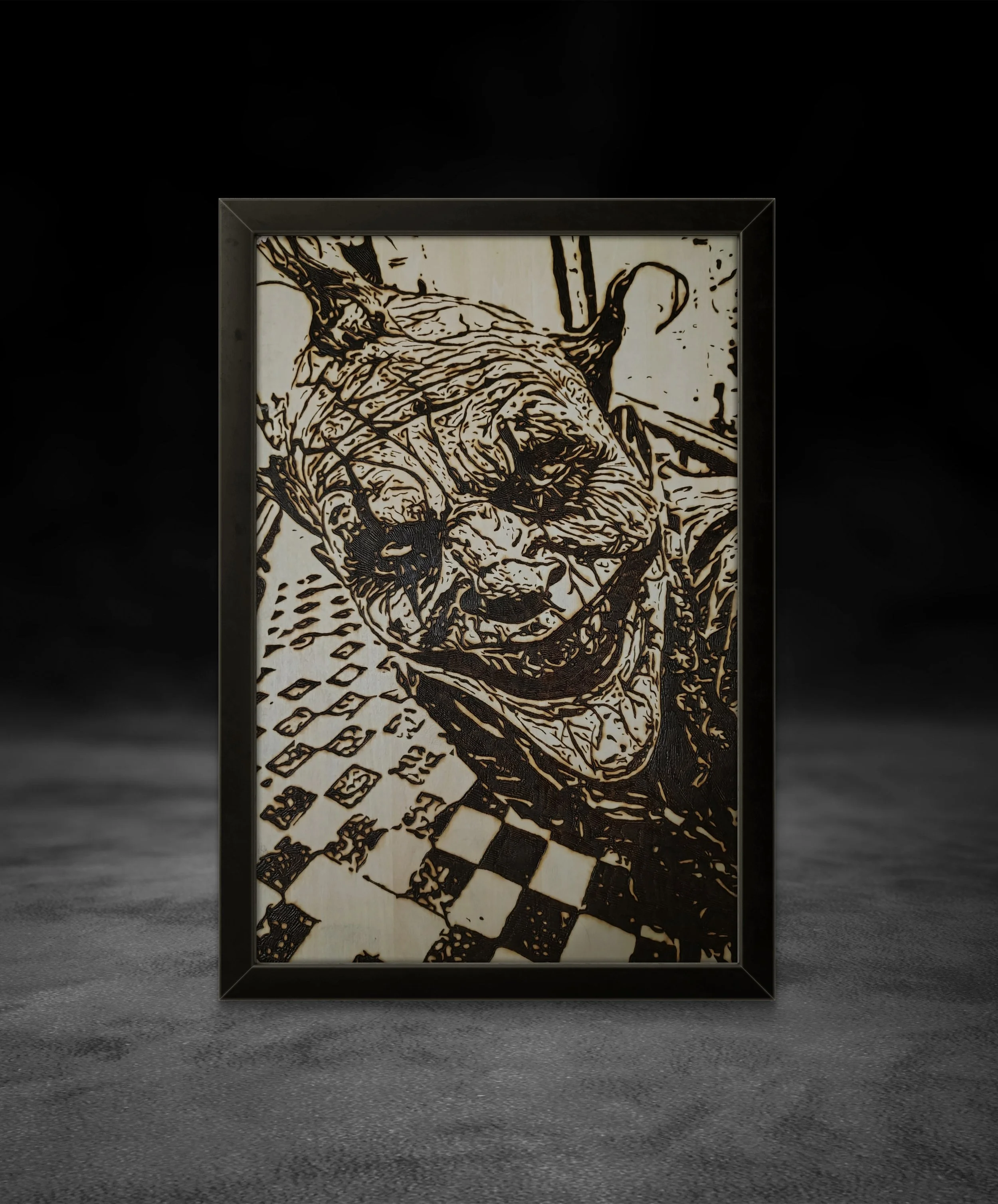 Framed wood burning wall art showing a chaotic smiling figure, handcrafted with detailed line work on basswood