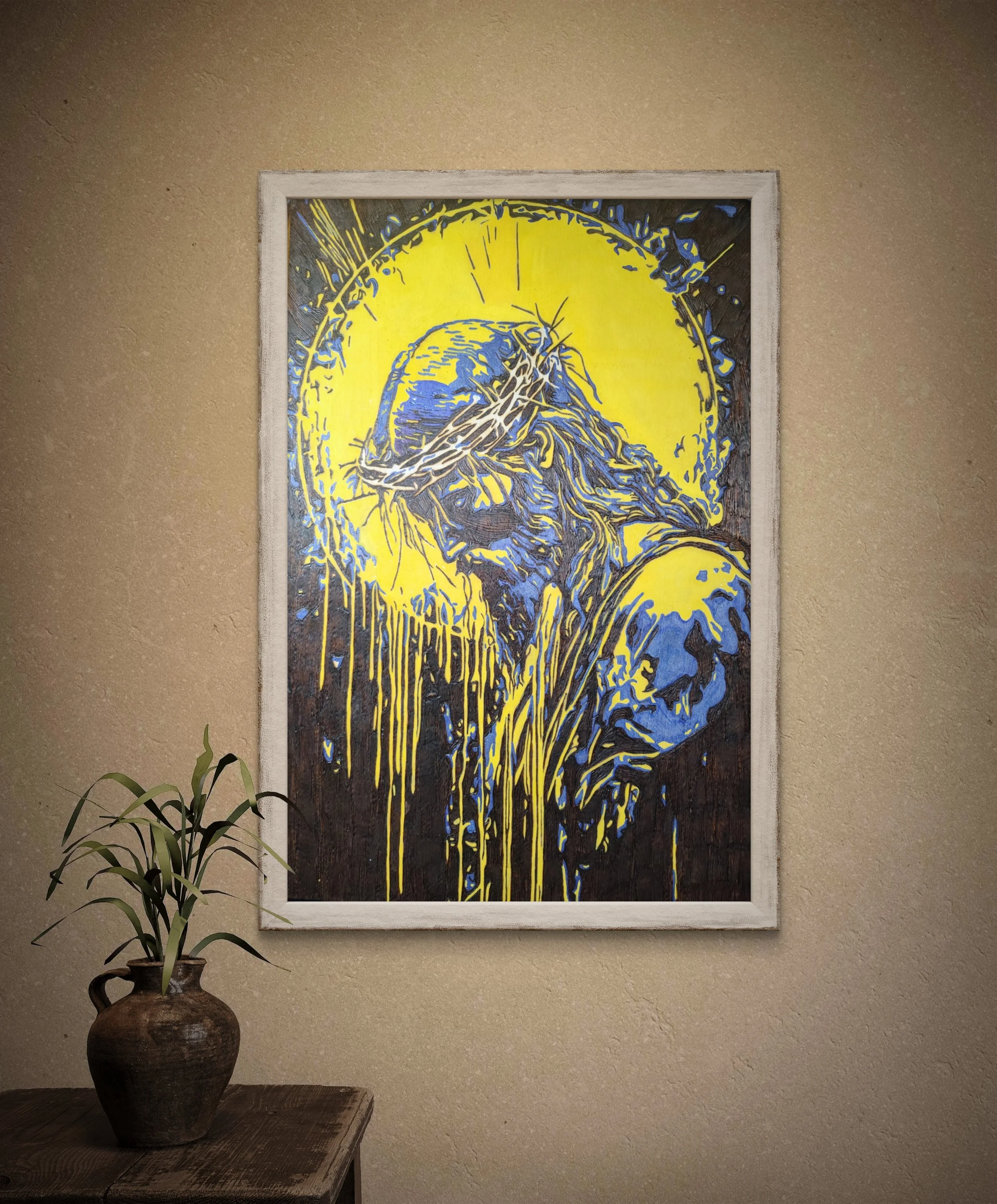 Framed wood burning artwork showing a sorrowful figure with dripping light imagery, symbolizing sacrifice and spiritual endurance