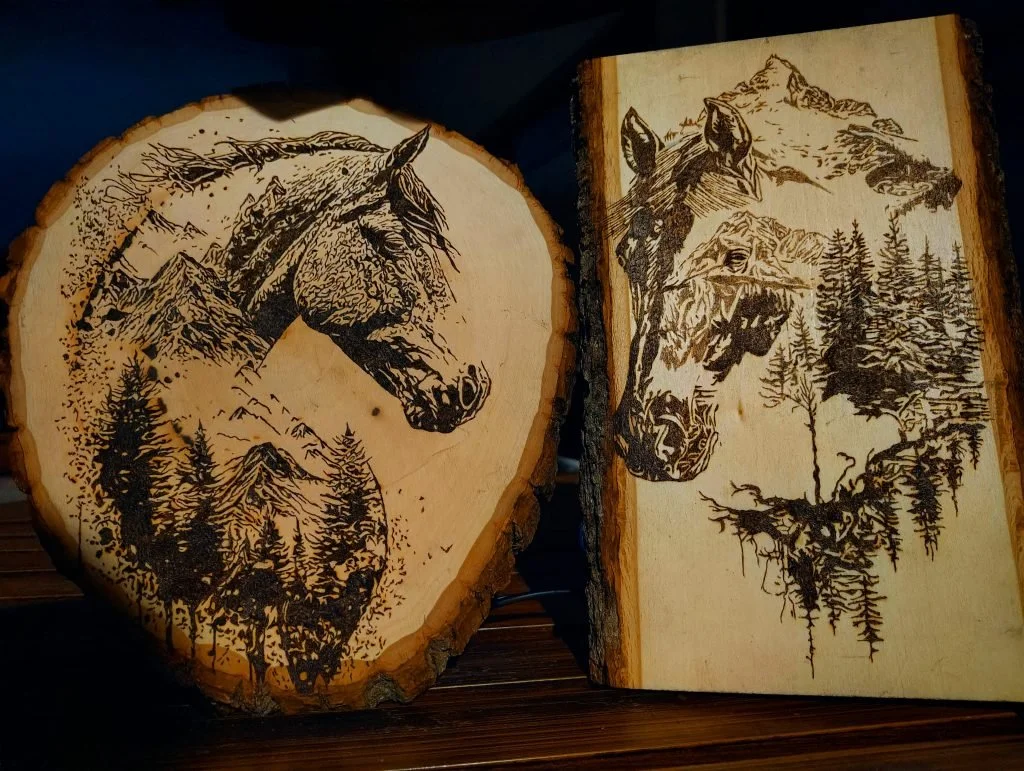 Handcrafted wood-burned animal artwork featuring a horse emerging from a mountainous forest landscape, detailed pyrography burned into live-edge wood slabs