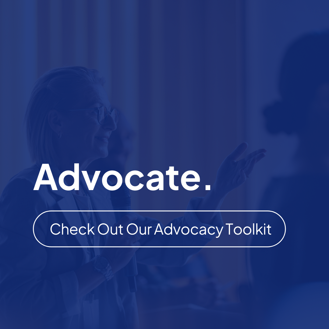 A woman standing in front of a group of people showcasing housing leadership organizations