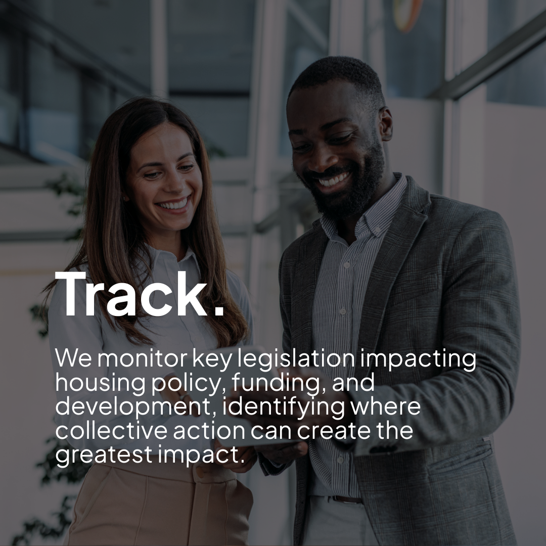 Two people going over paperwork about housing partnerships in Tennessee and smiling.