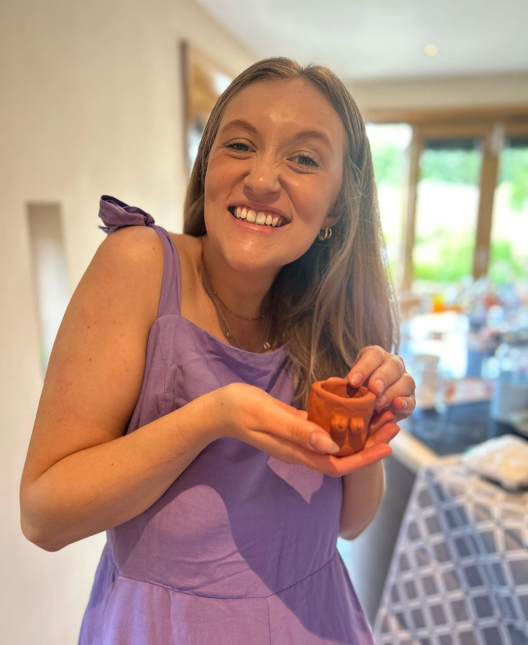 happy hen holding her finished boob pot