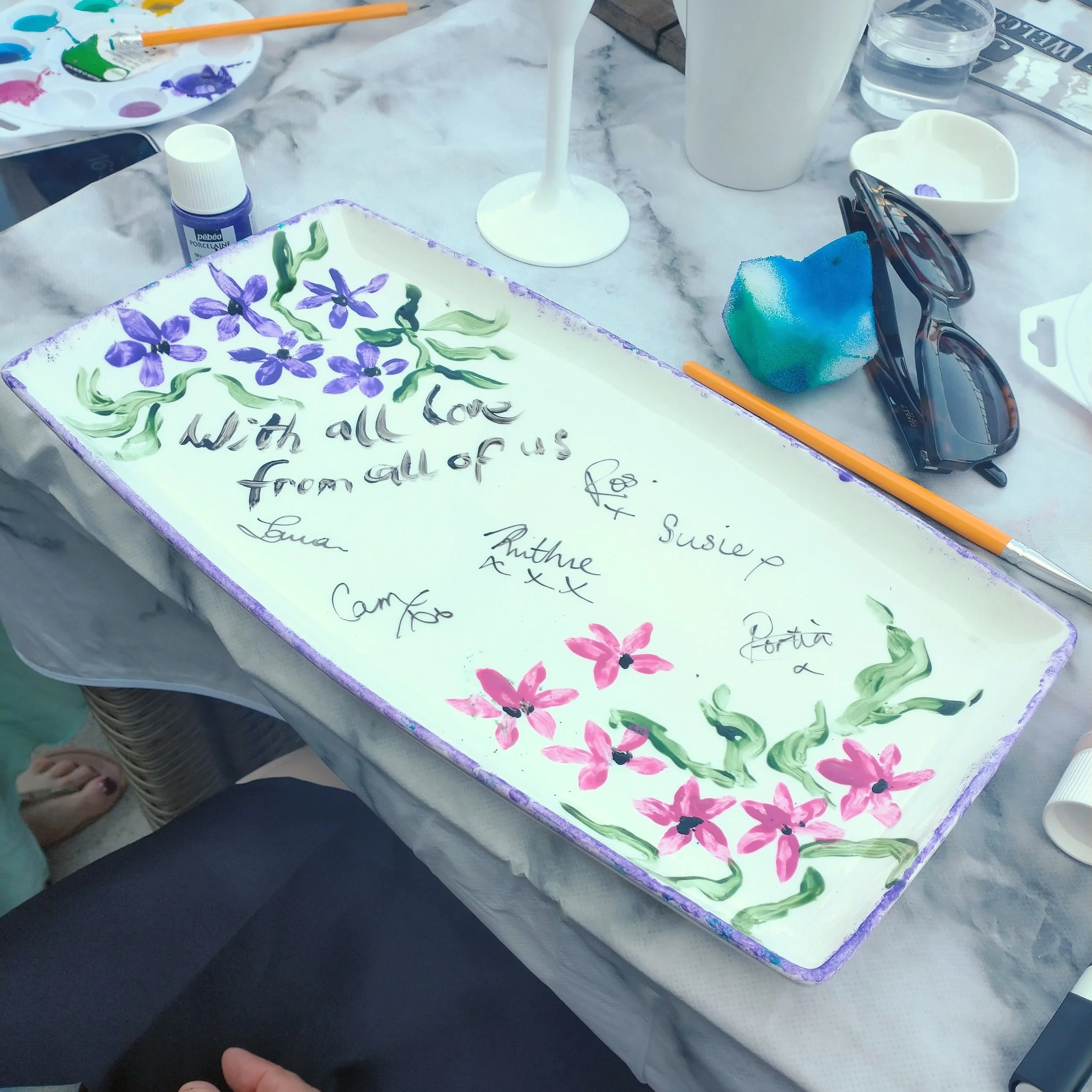a collaboration piece of ceramic signed by each hen at the hen party