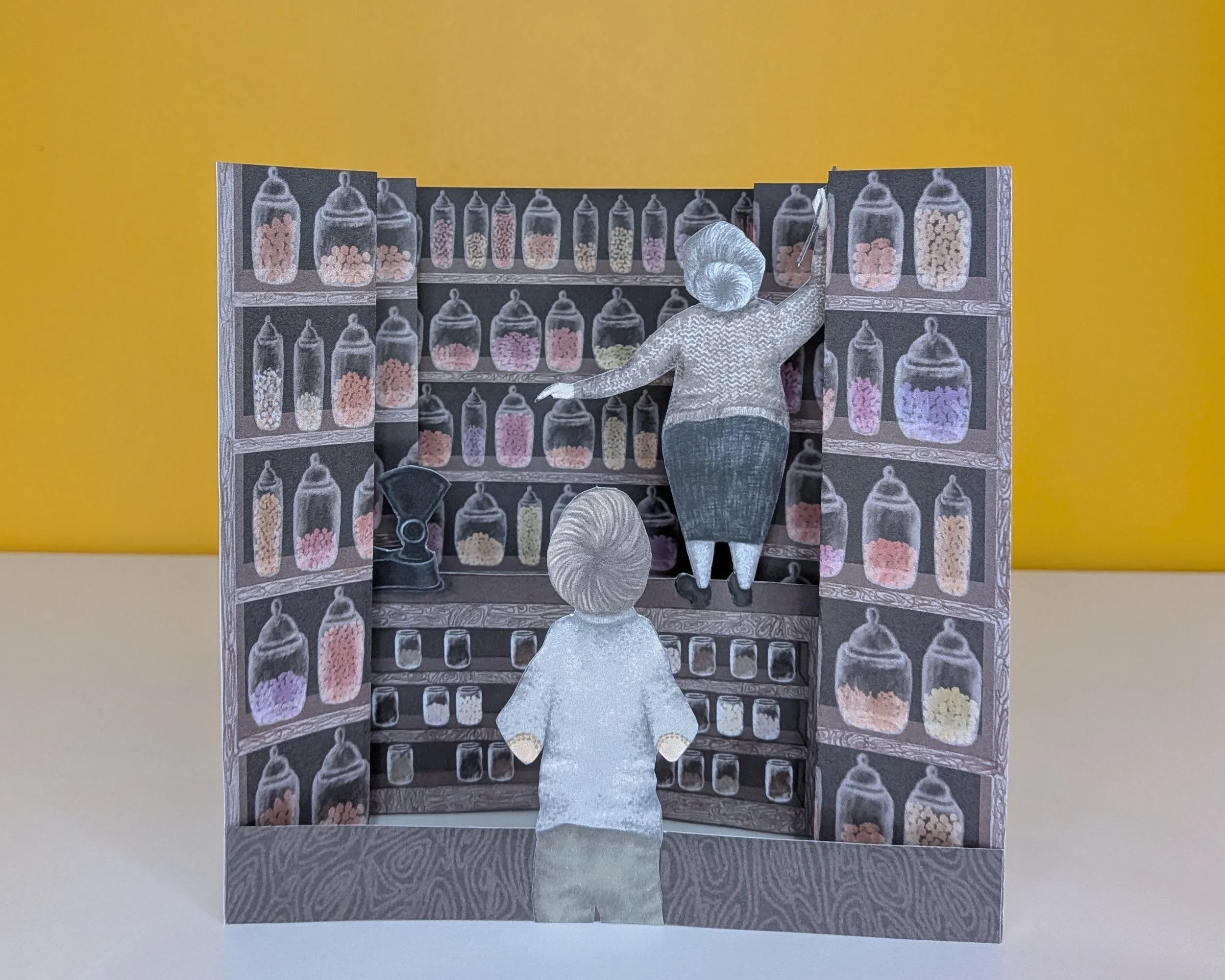 Tunnel book based on a memory of visiting the sweet shop and the shopkeeper having to reach up to the top shelves with a hook.