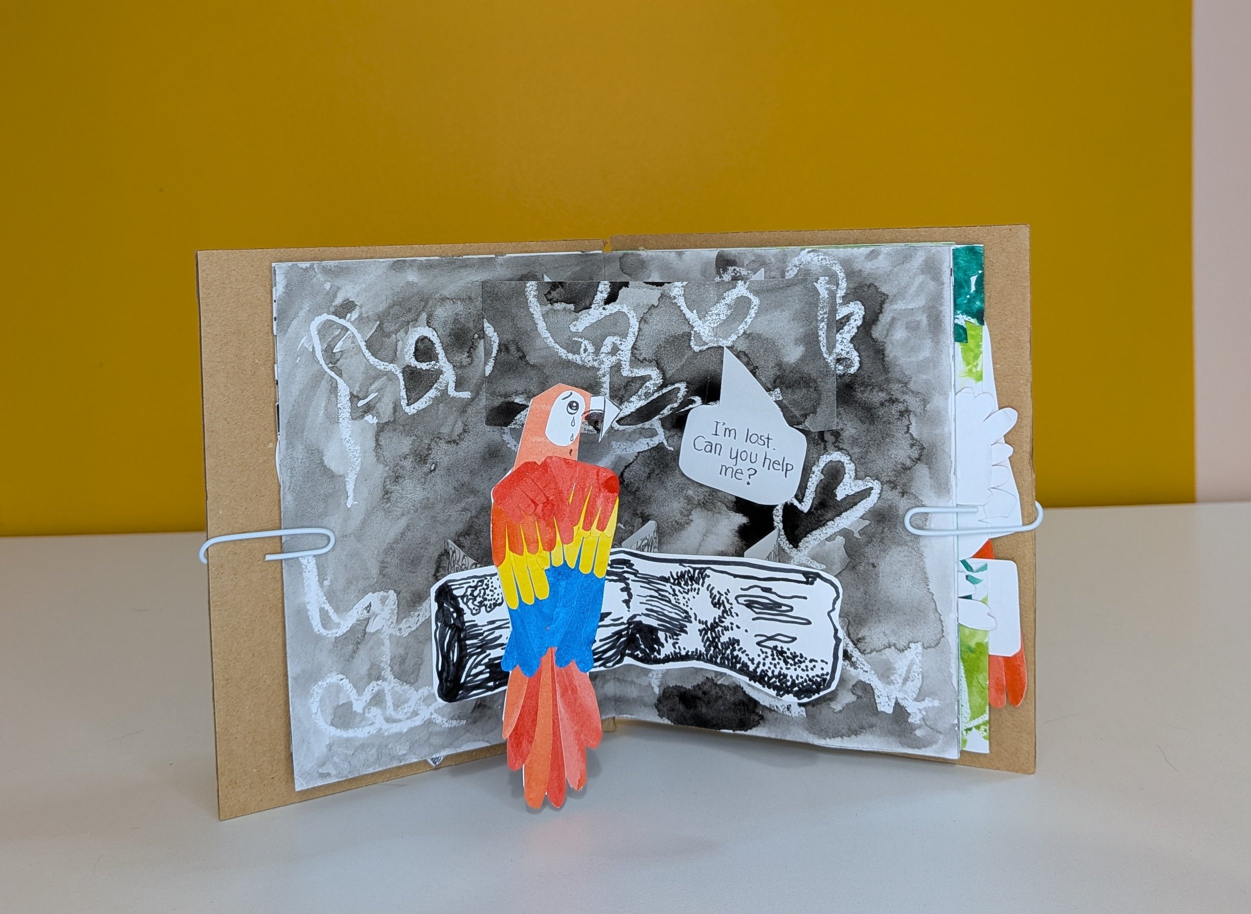Collaged parrot character in a pop-up scene, asking for help.