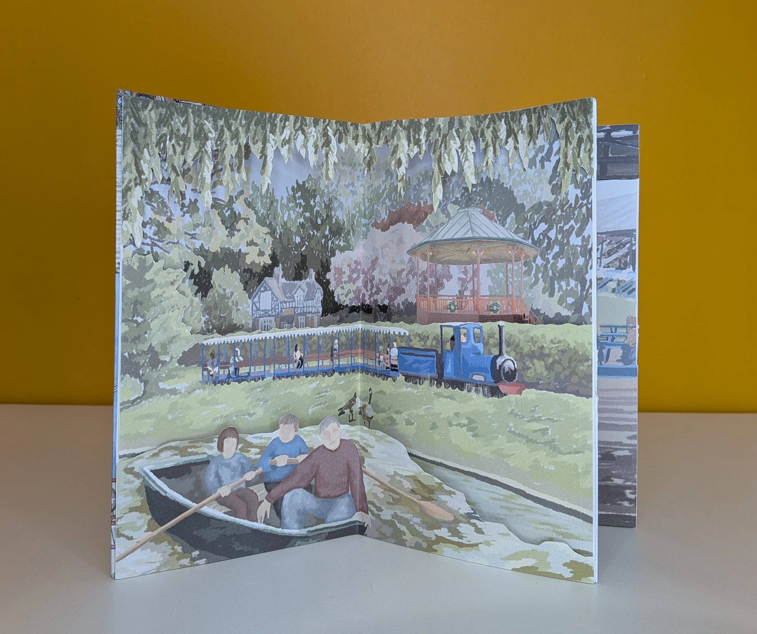 Queen's Park memory scene from my Chesterfield carousel book, showing the bandstand, train, and rowing boats.