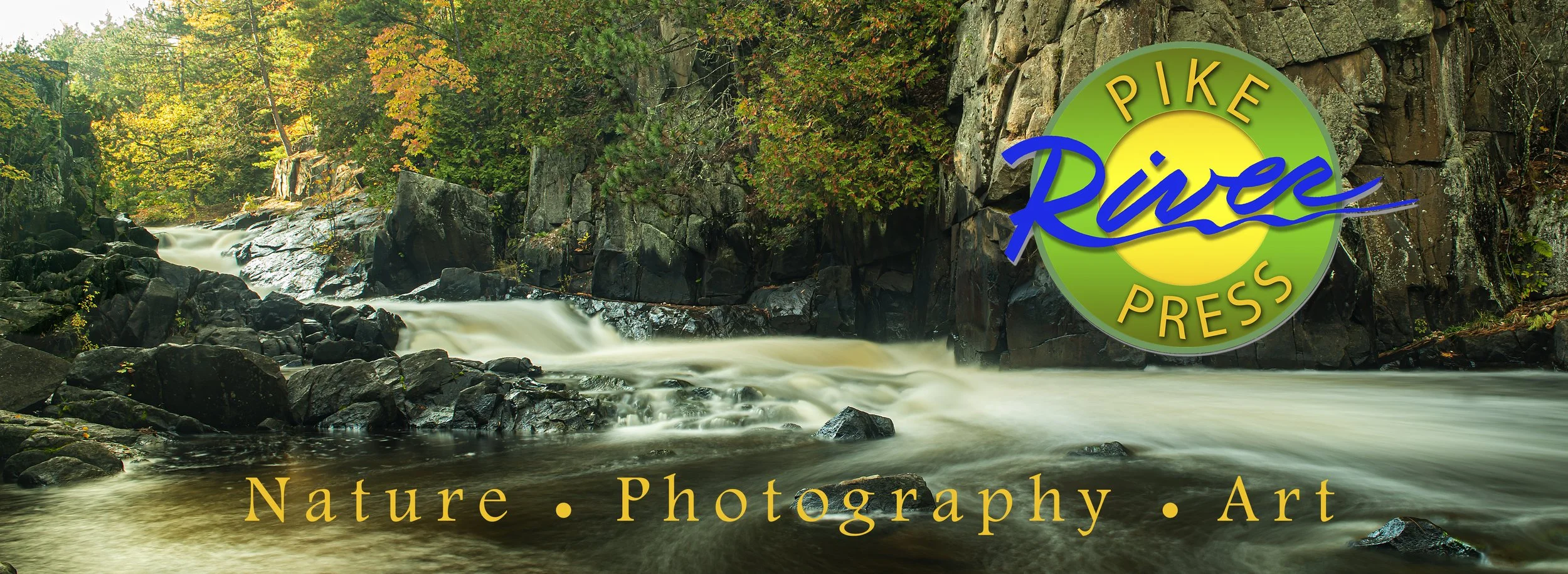 A panoramic photograph of Dave's Falls on the Pike River, surrounded by rocks and autumn-colored trees with a logo for Pike River Press in the foreground. The text below reads 'Nature · Photography · Art'.