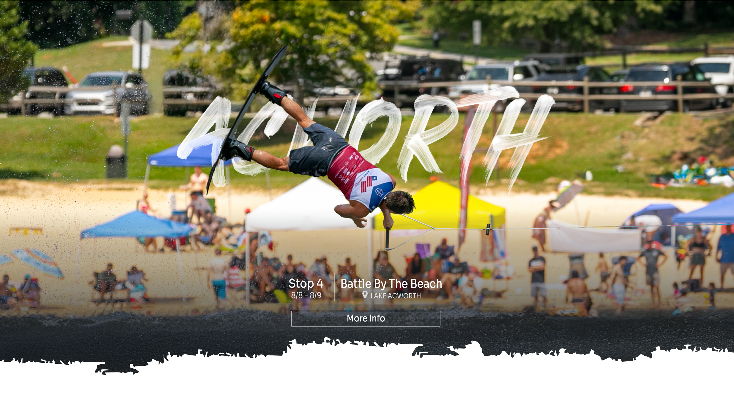 A person performing a trick on a wakeboard at the beach, with the word 'ACWORTH' spray-painted in the air above him. There are tents and people on the beach in the background.