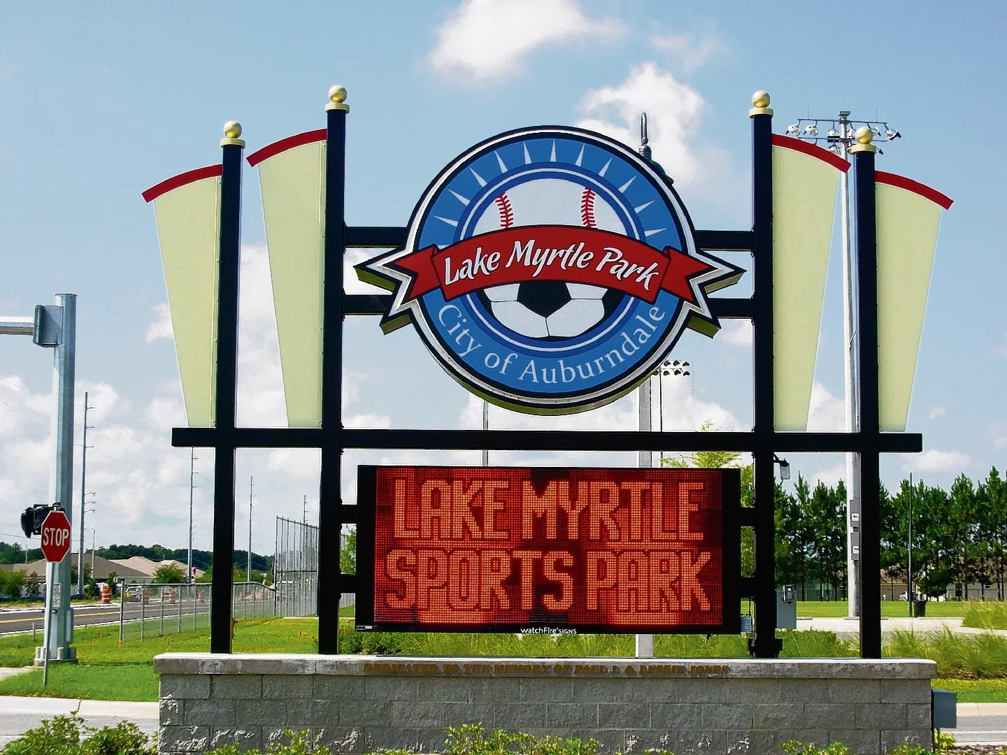 Sign for Lake Myrtle Park and Sports Park in Auburndale, Florida, with a digital message board displaying the park's name.