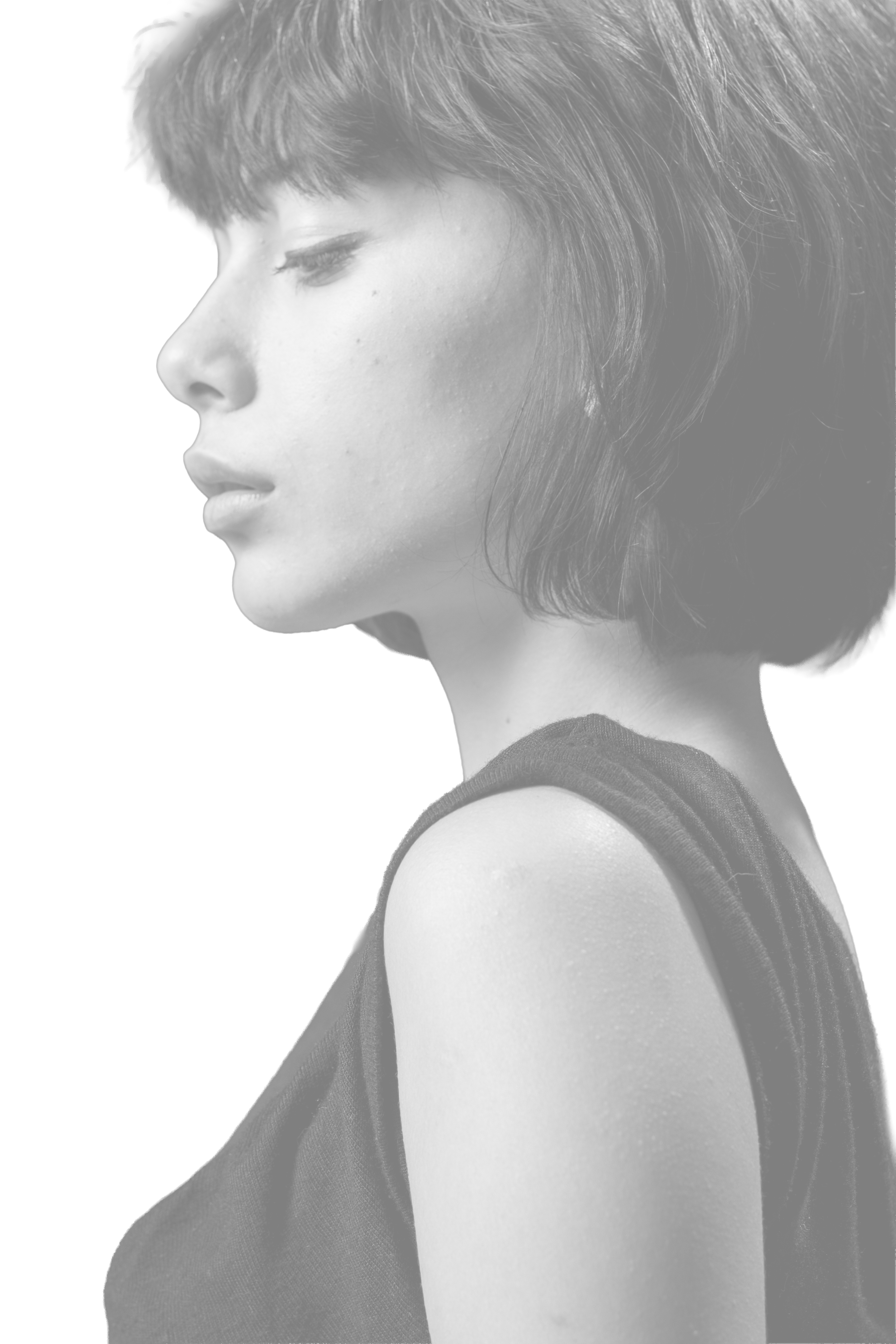 ritratto di una donna con capelli corti e scuri, in profilo, vestita di nero, con sfondo nero