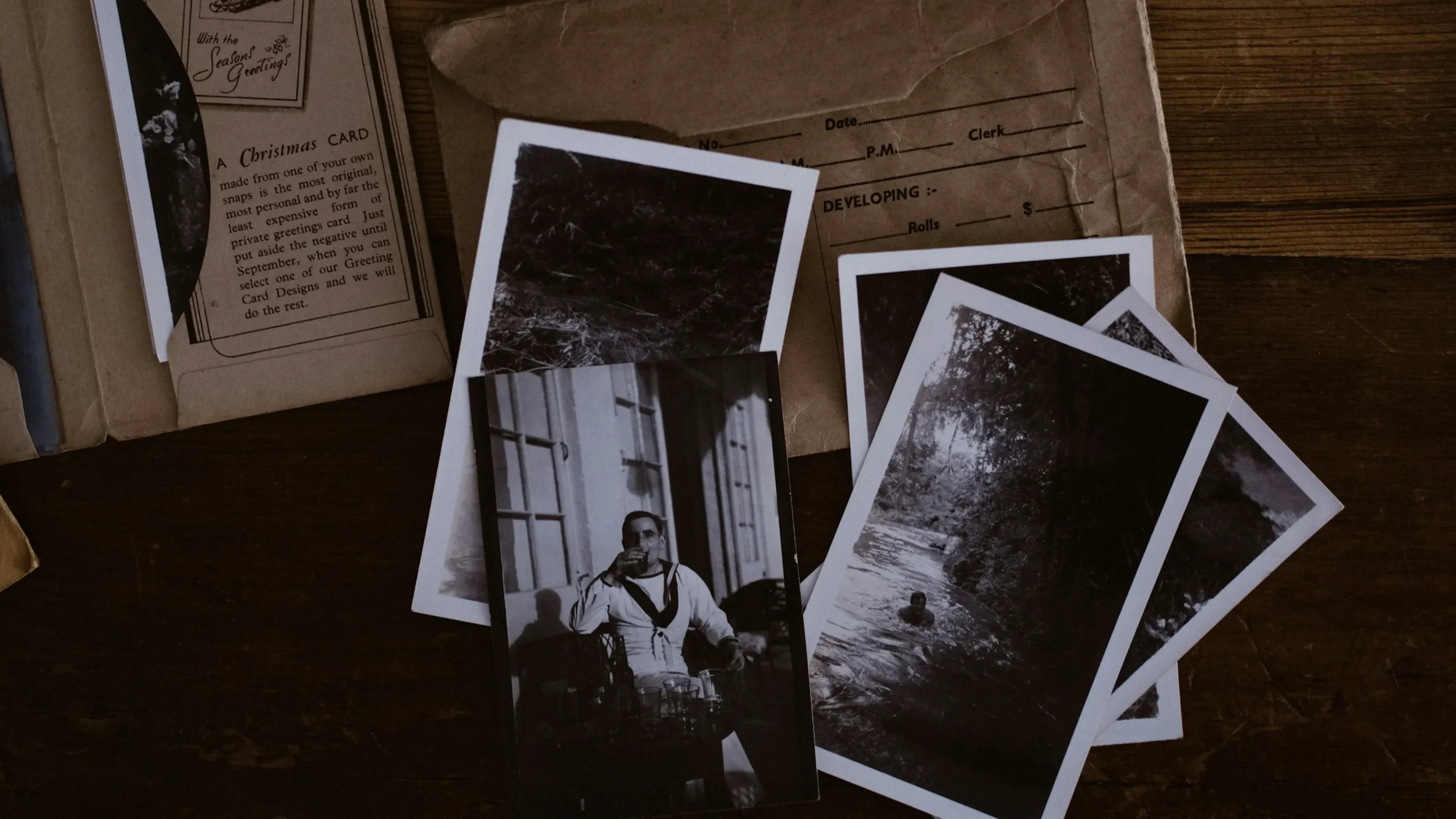 Vintage photos of a person's younger days laying on a table