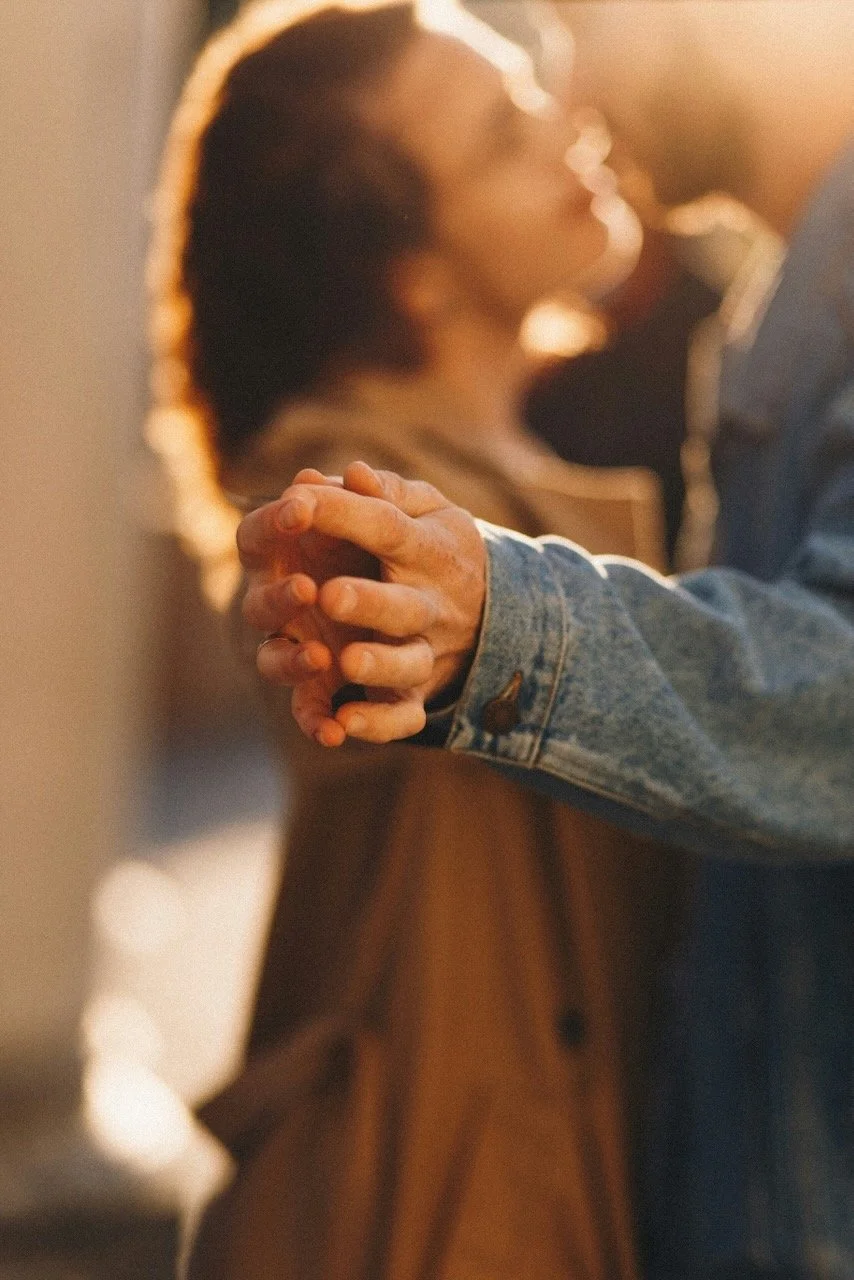 A couple looking in each others' eyes and holding hands