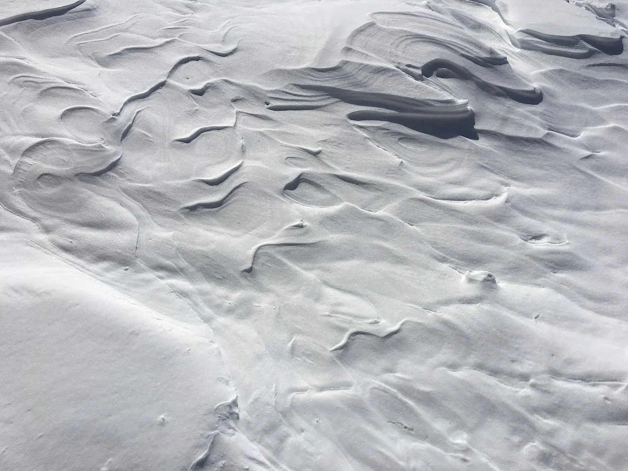 Snow drifts that have settled into new patterns