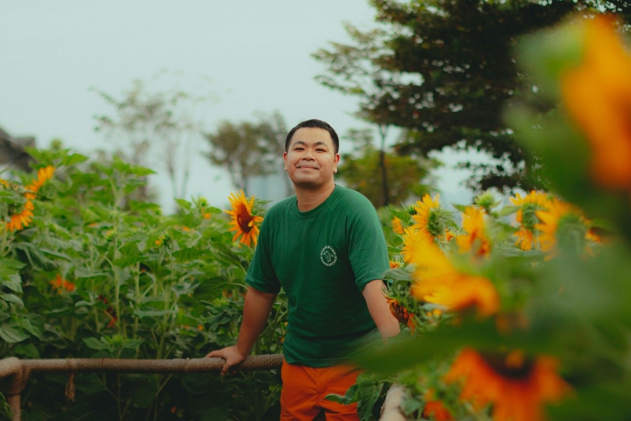 happy man in a flower field like post-traumatic growth after abuse recovery