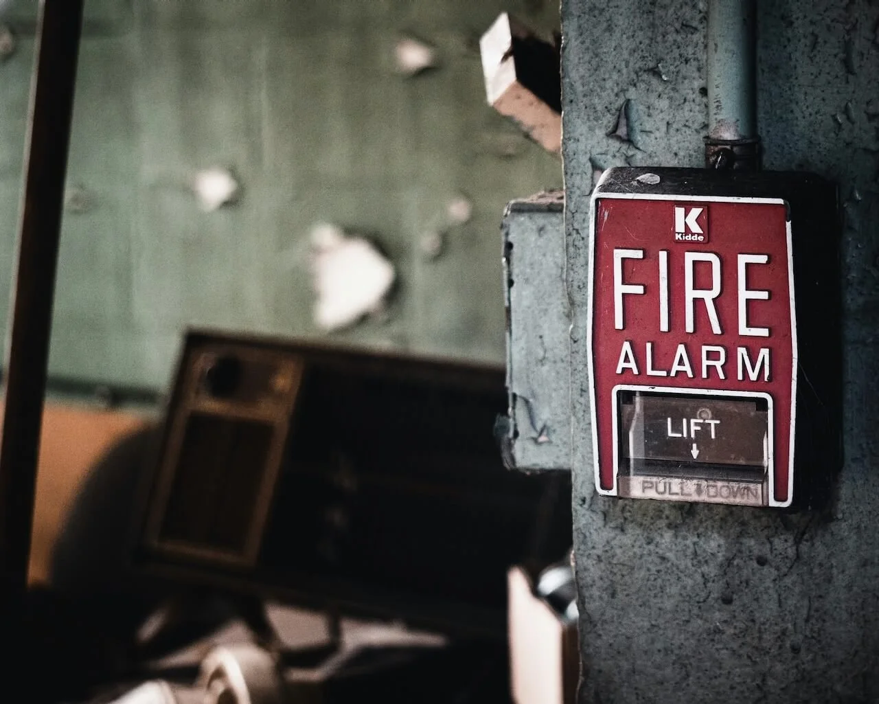 red fire alarm on a wall, like an anxiety alarm that won't turn off