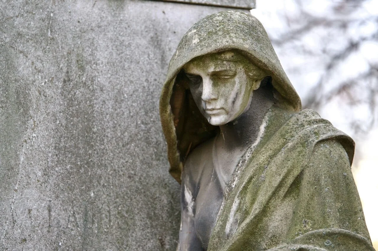 statue looking down with grief and overwhelm after betrayal trauma