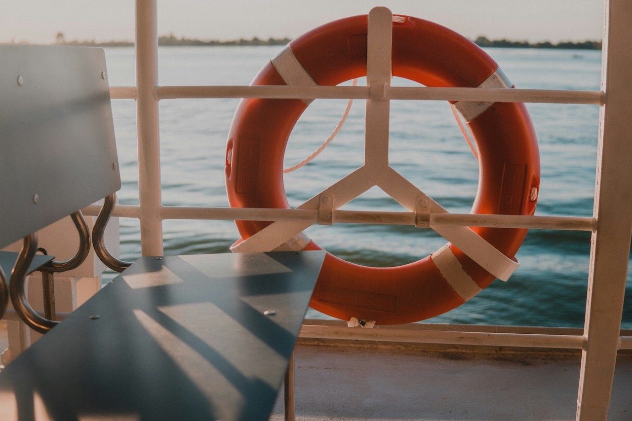 life preserver on a boat by an empty chair like the need for support after betrayal