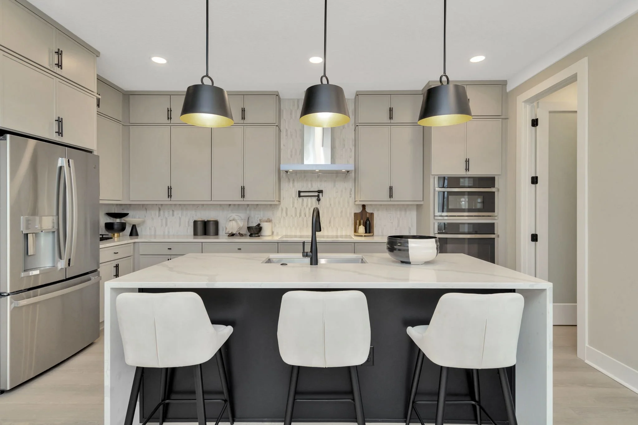 A DRB Homes Chef Kitchen Modeled at Primrose at Longleaf in New Port Richey, FL in the Cocoplum Home Plan.