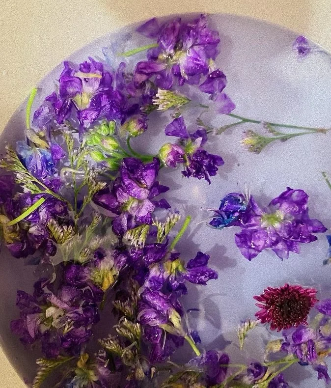 Purple and blue flowers on a light surface.