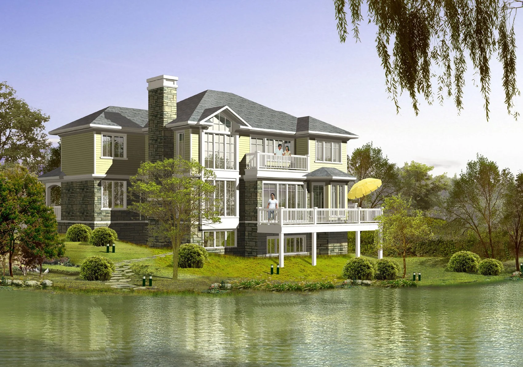 A large, multi-story house with stone and yellow siding, situated by a lake with trees and greenery, and two people standing on the balcony.