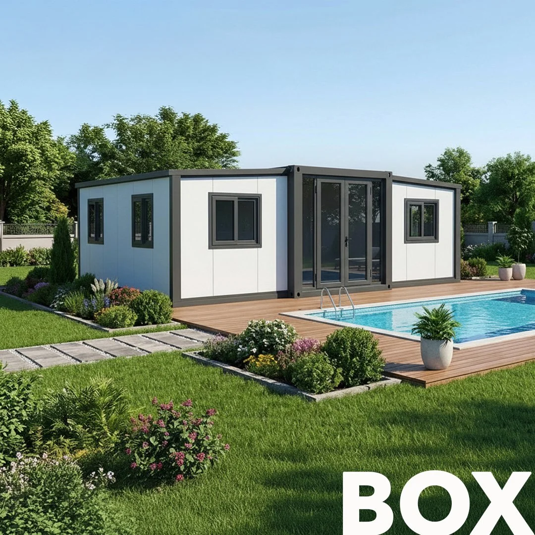 A modern backyard with a small prefabricated white and black container house, a wooden deck, a swimming pool, and landscaped green grass with bushes and flowers, under a clear blue sky.