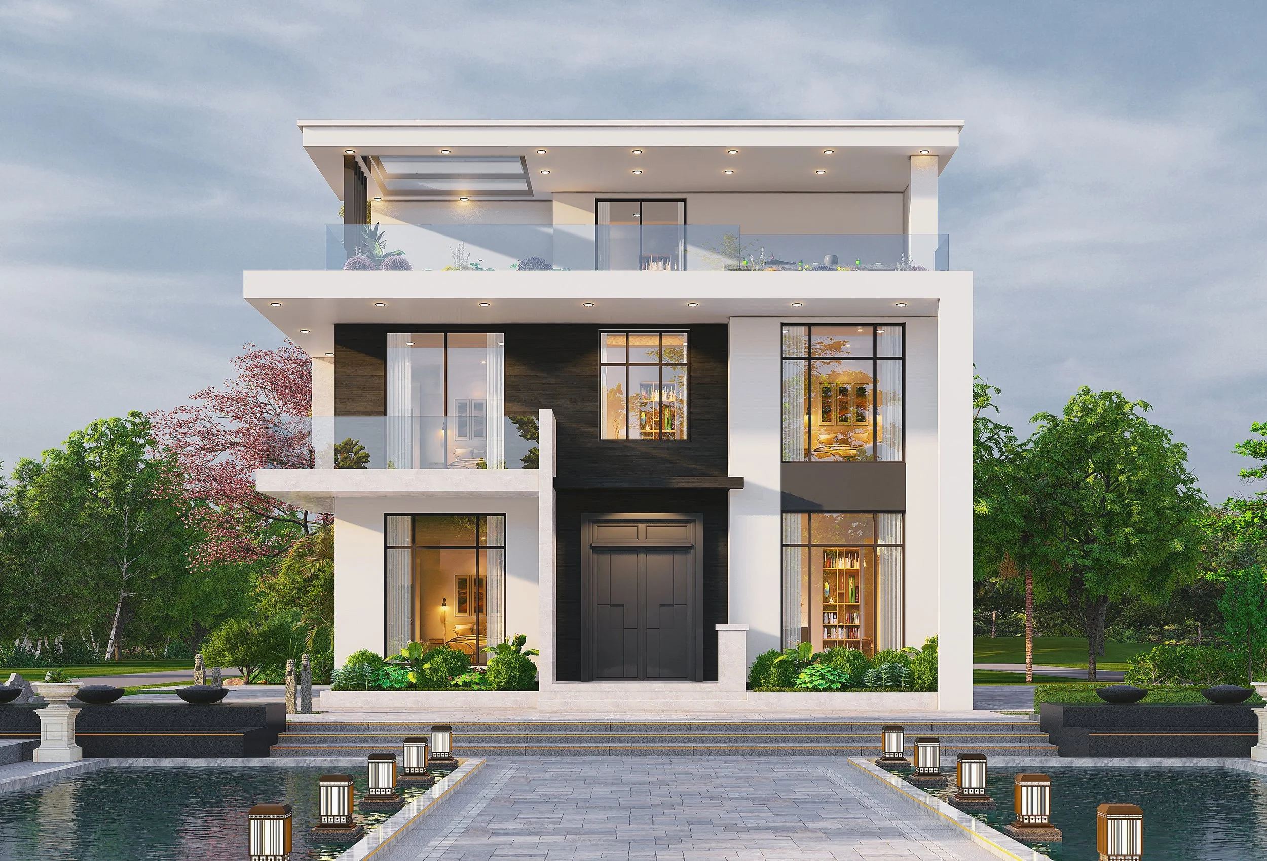 Modern multi-story house with large windows, surrounded by lush green trees, with a water feature and pathway in the front.