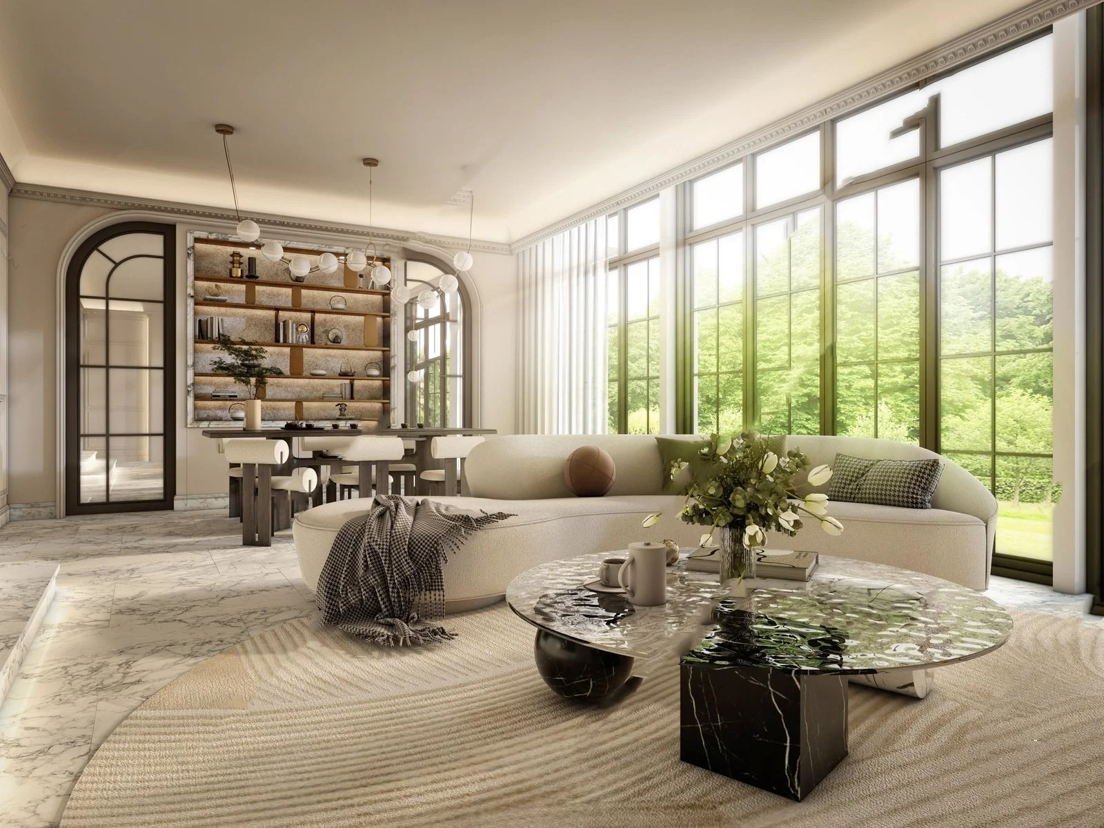Modern living room with large windows, cream sofa, marble coffee table with flowers and mugs, and a dining area with a built-in bookshelf.