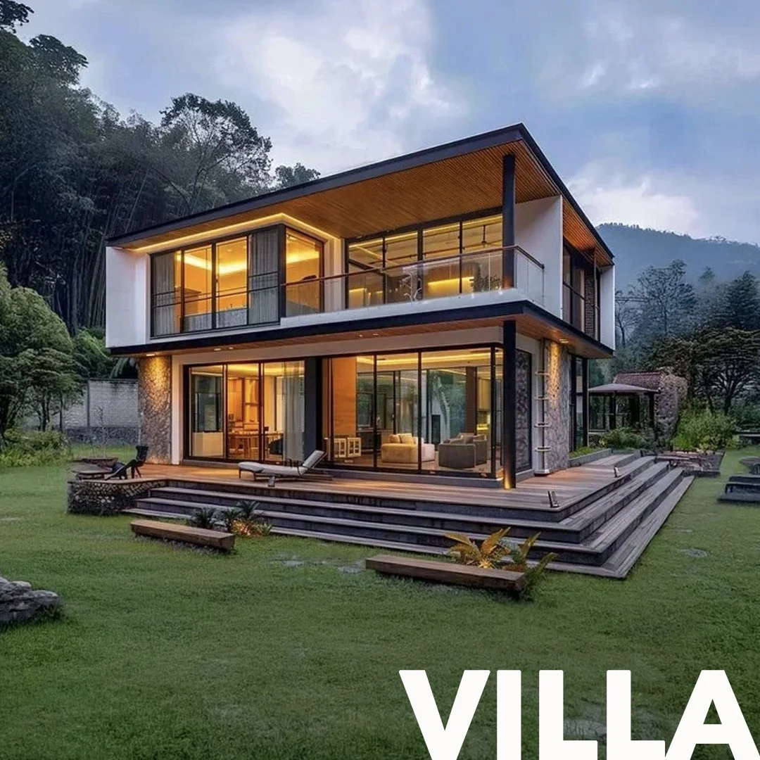 Modern two-story villa with large glass windows and a spacious wooden deck, surrounded by green lawn and trees, during dusk.