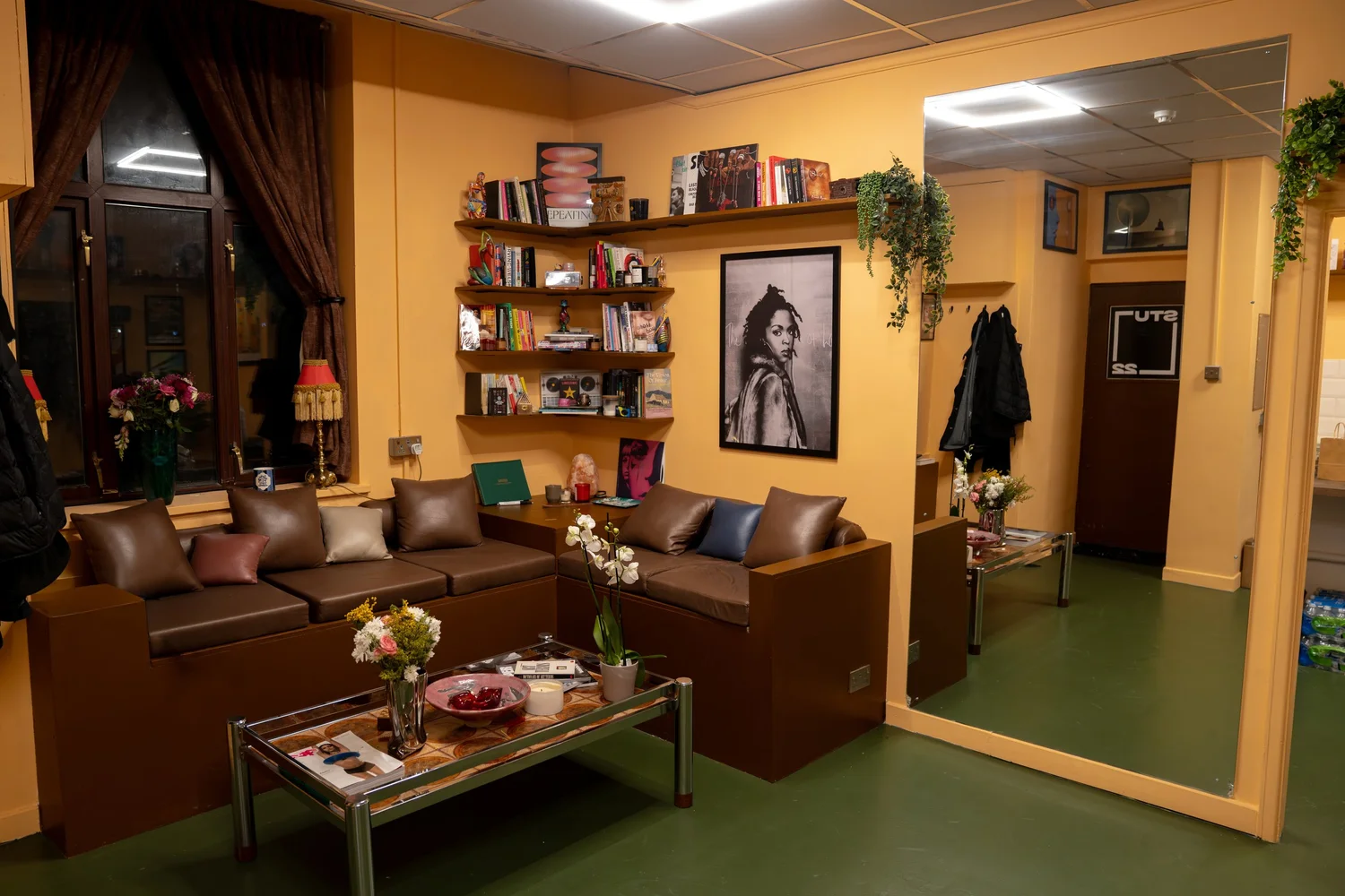 The Interim lounge at STU 22 Wapping with peach tones, books and vinyl shelves
